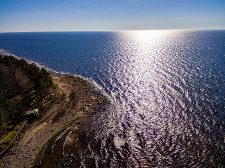 drone image. aerial view of rural area with rocky beach of Baltic sea. far horizon in calm dayの写真素材