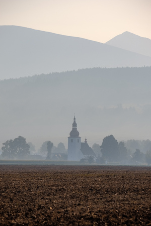 western carpathian mountain tops in  autumn covered in mist or clouds with blue cast and multidimensional linesの写真素材