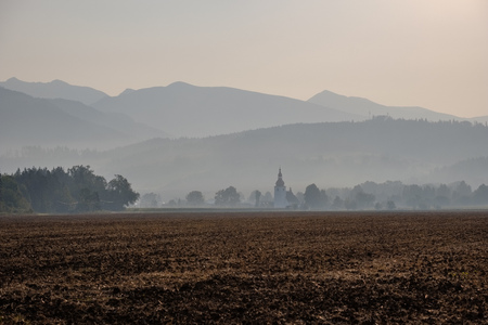 western carpathian mountain tops in  autumn covered in mist or clouds with blue cast and multidimensional linesの写真素材