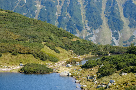 mountain lake panorama view in late summer in Slovakian Carpathian Tatra with reflections of rocky...