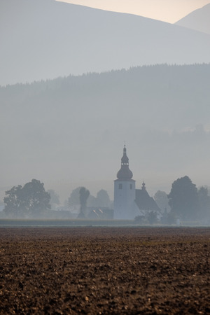 western carpathian mountain tops in  autumn covered in mist or clouds with blue cast and multidimensional linesの写真素材