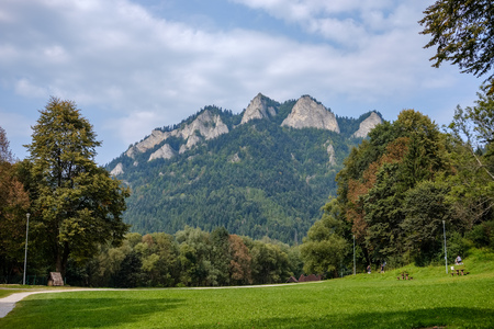 western carpathian Tatra mountain skyline with green fields and forests in foreground. summer in Slovakian hiking trailsの写真素材