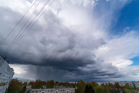 storm clouds forming over the countryside and fields with roadsの写真素材