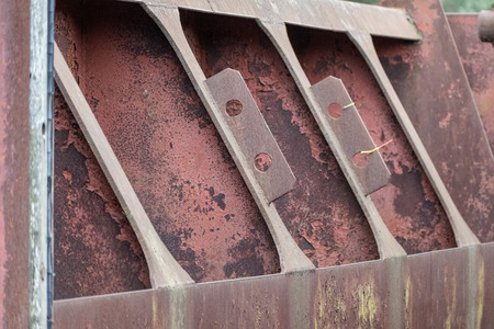 old red metal bridge over water. rusty details and close upsの写真素材