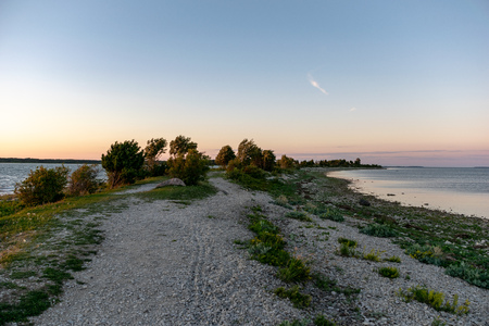 panoramic sea beach view in summer with rocks, plants and clean water in sunny day