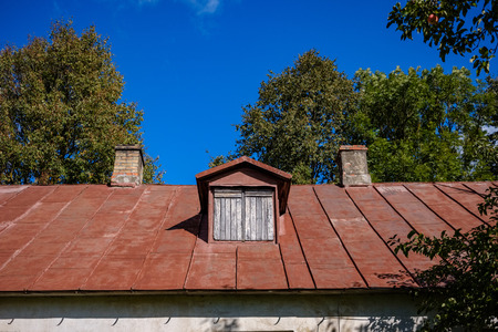country house roof top with chimney on blue sky backgroundの写真素材
