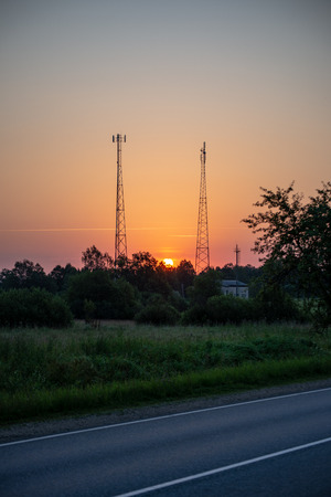 dramatic clouds on red sky over city roof tops at sunsetの写真素材