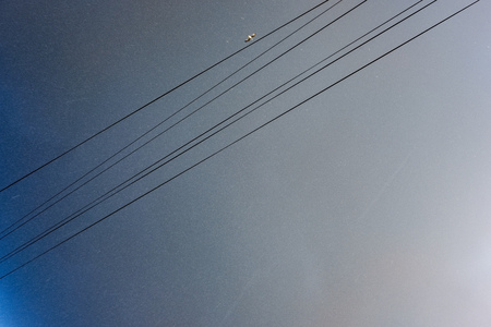 eletricity line poles and wires on blu sky in countryside environmentの写真素材