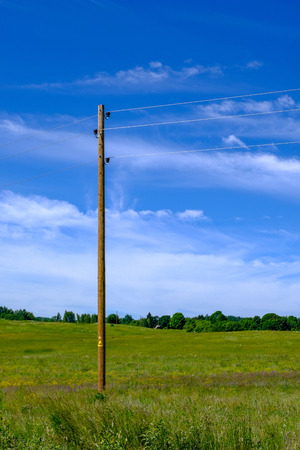 eletricity line poles and wires on blu sky in countryside environmentの写真素材