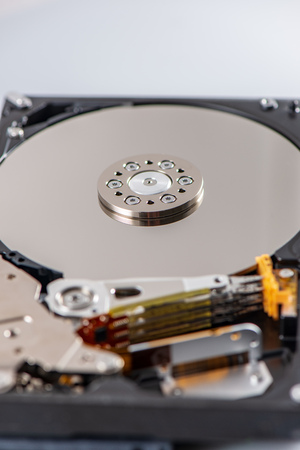hard disk rotating details. open up computer memory device with reading head and disk