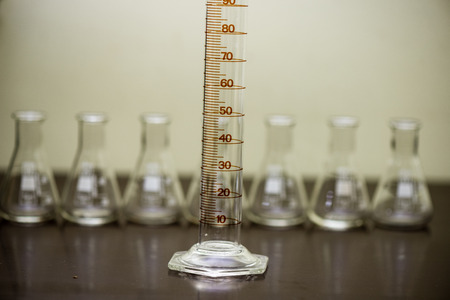 details of analog film laboratory equipment on the table. film rolls and development tank rolls with glass beaconsの写真素材