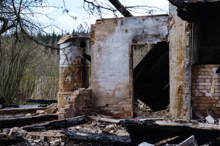 abandoned burned down house details, empty rooms and burnt wood logsの写真素材