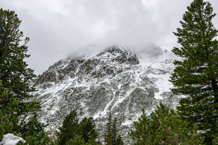 snow covered tourist trails for hiking in slovakia tatra mountains. sunny winter day with clouds and...