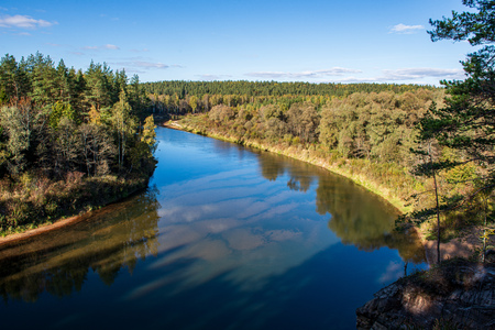 scenic river view landscape of forest rocky stream with trees on the shores. beautiful lightの写真素材