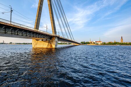details of cable bridge in Riga latvia in summer by the river of Daugava, evening landscape