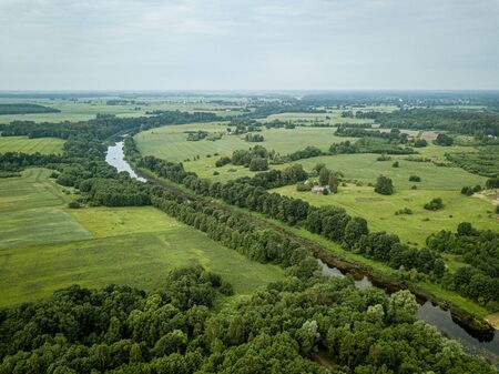 country river in green forest. drone aerial image from birds eye