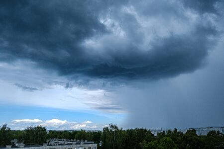 dramatic rain clouds over city rooftops in autumn