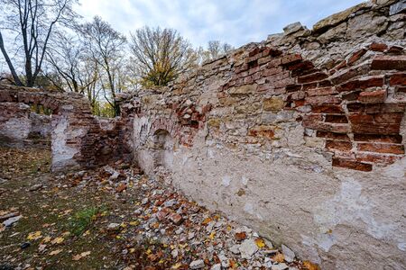 old red brick ruins of ancient castle in autumn colored natue. latviaの写真素材