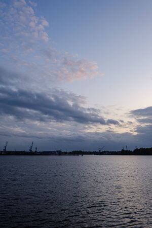 night clouds and lights above industrial port of city Riga in Latvia. nightfallの写真素材