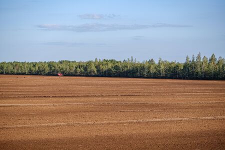countryside fields and meadows in autumn. scenic view landscape in Latvia country with forest in backgroundの写真素材