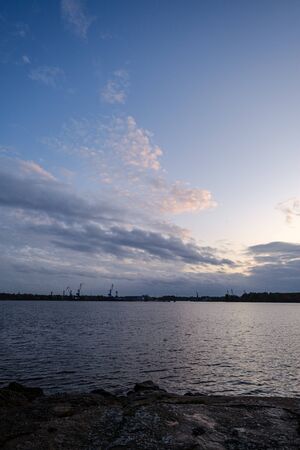 night clouds and lights above industrial port of city Riga in Latvia. nightfallの写真素材