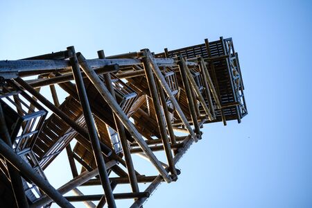 wooden stairs to watch tower in wet colored autumn day in countryside landscapeの写真素材
