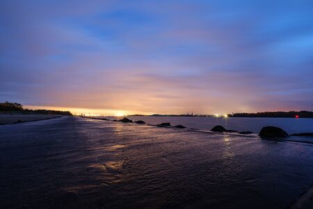 night clouds and lights above industrial port of city Riga in Latvia. nightfallの写真素材