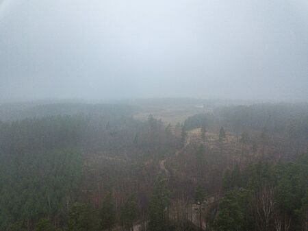 fog over forests and lakes in countryside. drone image from above. aerialの写真素材