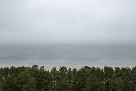seaside beach with water covered in fog mist. drone aerial imageの写真素材