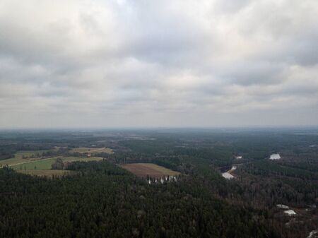 River in winter forest with green trees from above. Aerial drone image of river Gauja in Latvia.の写真素材