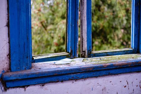 old abandoned house interior with broken furniture and empty windows. woodwork details in dustの写真素材