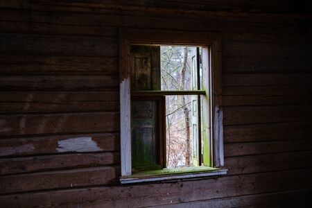 old abandoned house interior with broken furniture and empty windows. woodwork details in dustの写真素材