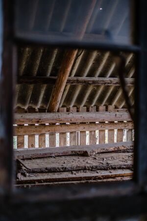 old abandoned house interior with broken furniture and empty windows. woodwork details in dustの写真素材