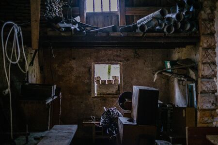 old abandoned house interior with broken furniture and empty windows. woodwork details in dustの写真素材