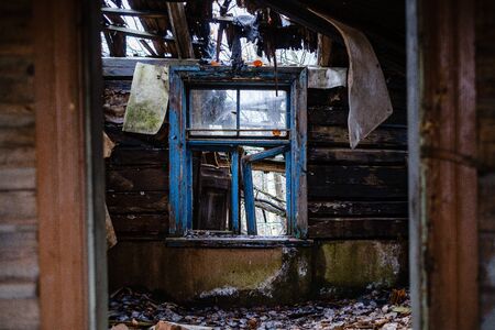 old abandoned house interior with broken furniture and empty windows. woodwork details in dustの写真素材