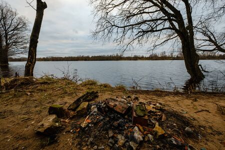 autumn river with flooded shore with trees in the waterの写真素材