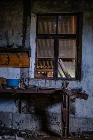 old abandoned house interior with broken furniture and empty windows. woodwork details in dustの写真素材