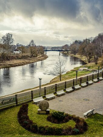 old wooden bridge over the river in forest