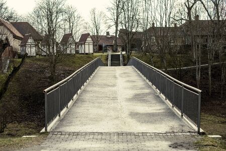 old wooden bridge over the river in forestの写真素材