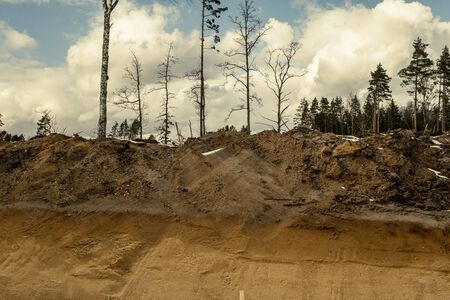 construction site of new road in forest in winter with snow and mudの写真素材