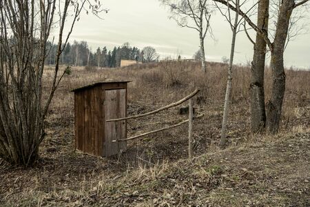 resting camping place in the woods with benches and trail in late autumn in Latvia