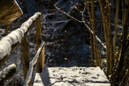 snowy pathway for walking in forest in winter, sunny day with stairs under snowの写真素材