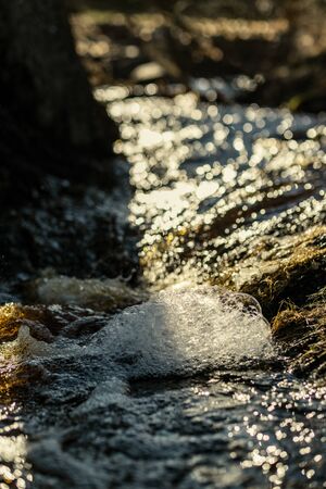 waves crushing on the rocks on beach in sunny day with blue sky and clear water on the sand texture....