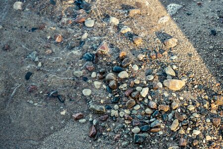 sunny beach with blue water and large rocks in the sand. Latvia under clear skyの写真素材