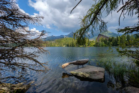 autumn nature reflection in lake of Strbske Pleso in Slovakia surrounded by trees and mountainsのeditorial素材