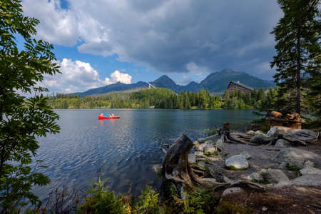 autumn nature reflection in lake of Strbske Pleso in Slovakia surrounded by trees and mountainsのeditorial素材