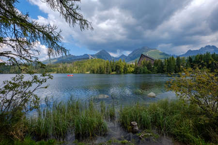 autumn nature reflection in lake of Strbske Pleso in Slovakia surrounded by trees and mountainsのeditorial素材