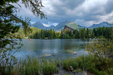 autumn nature reflection in lake of Strbske Pleso in Slovakia surrounded by trees and mountainsのeditorial素材