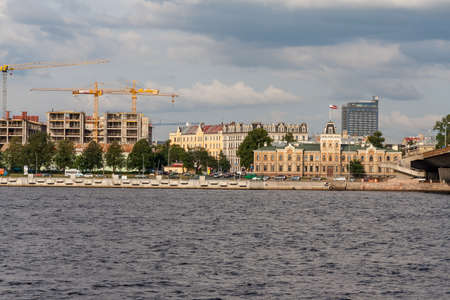 Riga city, capital of Latvia panoramic view with river Daugava and cable bridge with calm water in summerのeditorial素材