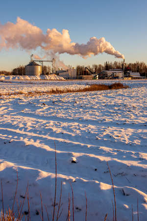 industrial smoke from large chimneys in winter. white smoke steamのeditorial素材